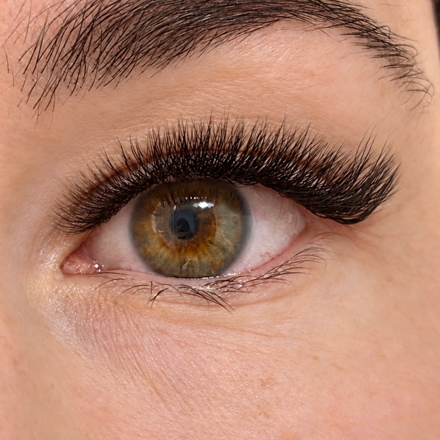 Close-up of finished lash extensions on an open eye